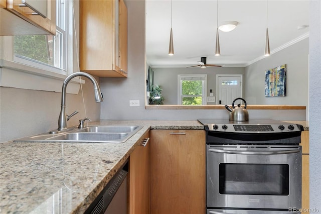 kitchen with sink, ceiling fan, ornamental molding, appliances with stainless steel finishes, and light stone counters