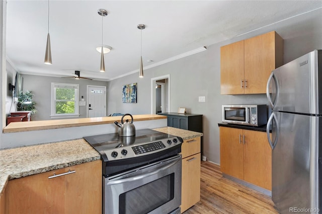 kitchen featuring ceiling fan, hanging light fixtures, light stone counters, appliances with stainless steel finishes, and ornamental molding