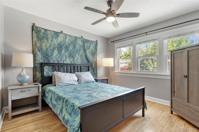 bedroom with ceiling fan and light wood-type flooring