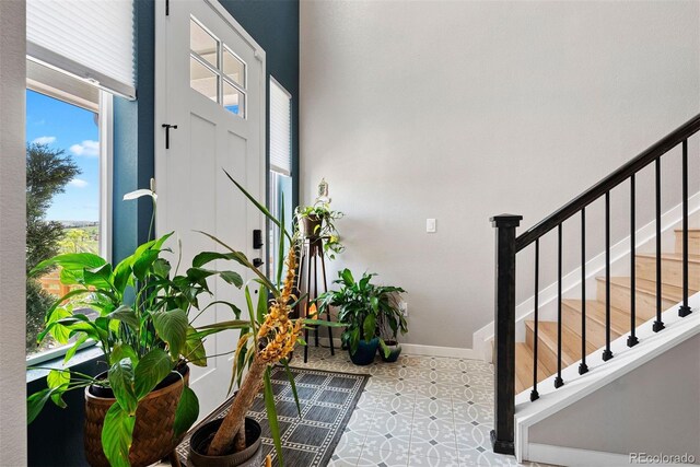 15020 Cast Pebble Cir, Parker, CO 80134 - foyer entrance with stairway, tile patterned floors, and baseboards