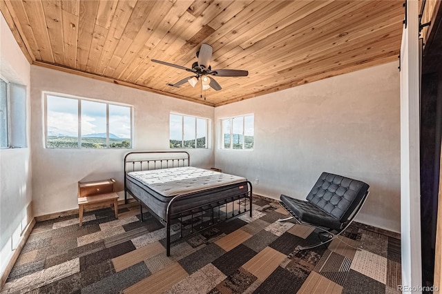 bedroom featuring ceiling fan, ornamental molding, and wooden ceiling