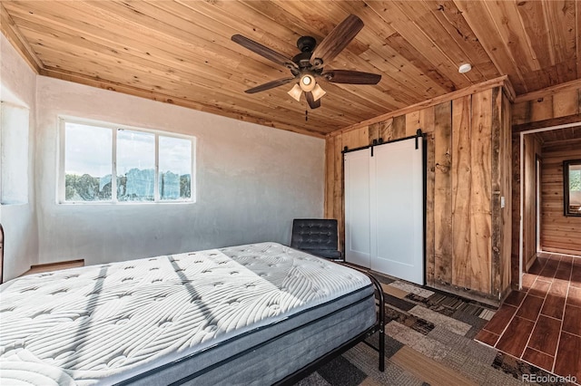 7727 County Road 521, Walsenburg, CO 81089 - bedroom with a barn door, wood ceiling, wood walls, and a closet