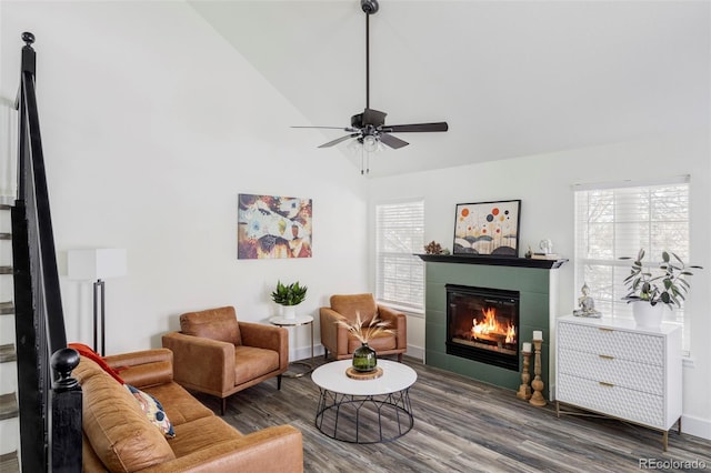 sitting room with a fireplace, hardwood / wood-style flooring, vaulted ceiling, and ceiling fan