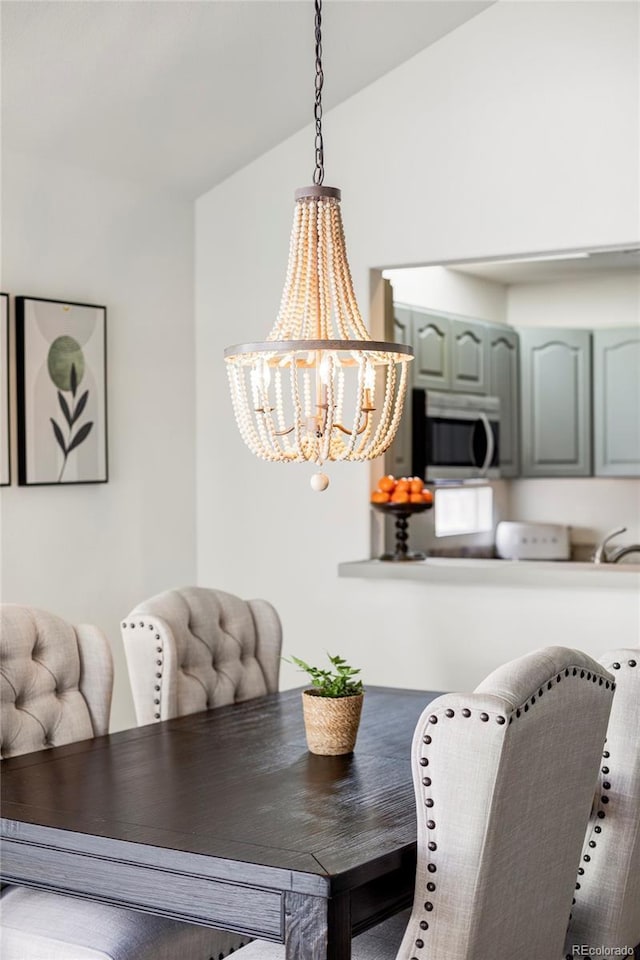 dining room featuring lofted ceiling and a chandelier