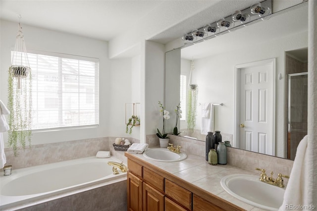 bathroom featuring double vanity, a stall shower, a sink, and a bath