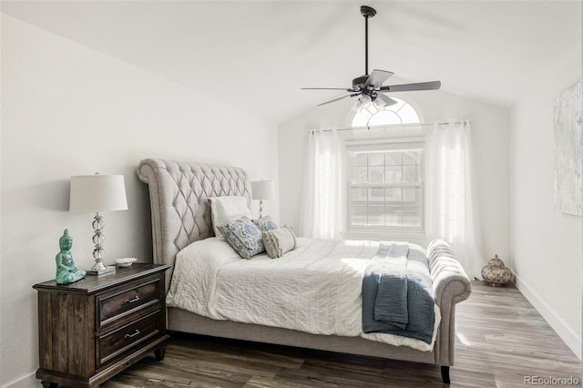 bedroom with lofted ceiling, dark wood-style flooring, a ceiling fan, and baseboards