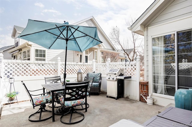 view of patio featuring outdoor dining area, area for grilling, and fence