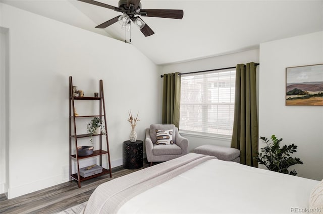 bedroom featuring vaulted ceiling, wood finished floors, a ceiling fan, and baseboards