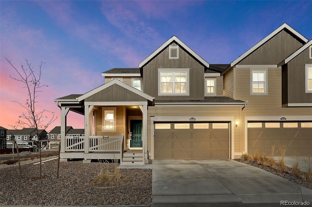 view of front facade featuring a porch and a garage