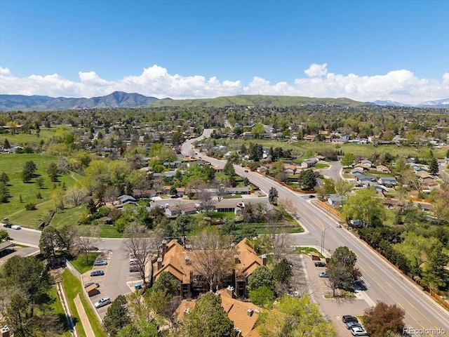 aerial overview of property's location with a mountain backdrop and nearby suburban area