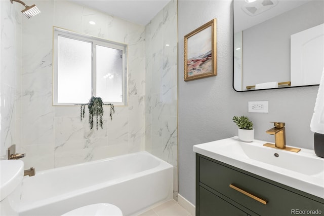 full bathroom featuring tile patterned floors, tiled shower / bath combo, vanity, and toilet