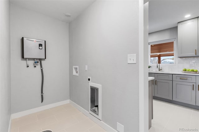 laundry area with sink, light tile patterned floors, electric dryer hookup, and hookup for a washing machine