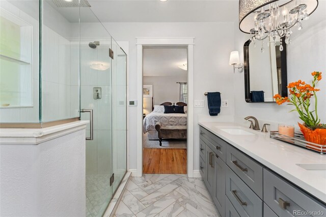 27436 Kennedy Gulch Rd, Conifer, CO 80433 - bathroom featuring marble look tiles, a shower stall, double vanity, and ensuite bath