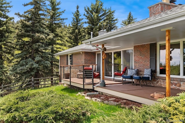 27436 Kennedy Gulch Rd, Conifer, CO 80433 - back of house featuring brick siding, a chimney, and a deck