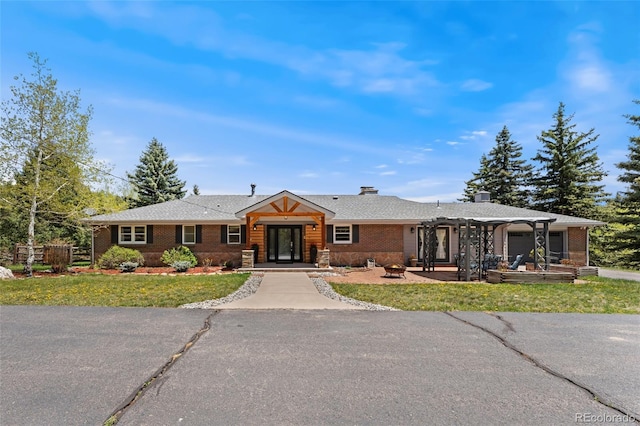 27436 Kennedy Gulch Rd, Conifer, CO 80433 - single story home with brick siding, a fire pit, a front lawn, and a patio area