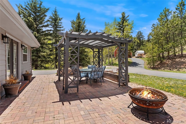 27436 Kennedy Gulch Rd, Conifer, CO 80433 - view of patio featuring an outdoor fire pit, a pergola, and outdoor dining space
