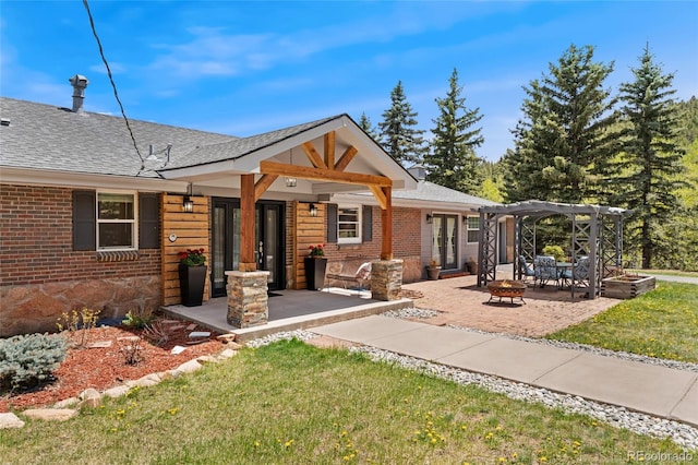27436 Kennedy Gulch Rd, Conifer, CO 80433 - view of front of property with an outdoor fire pit, a pergola, a front lawn, and brick siding