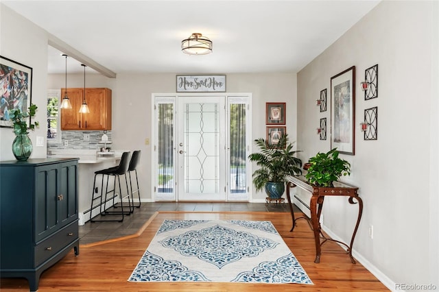 27436 Kennedy Gulch Rd, Conifer, CO 80433 - foyer entrance featuring wood finished floors and a baseboard radiator
