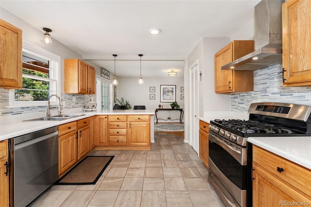 27436 Kennedy Gulch Rd, Conifer, CO 80433 - kitchen featuring wall chimney exhaust hood, appliances with stainless steel finishes, a peninsula, backsplash, and recessed lighting