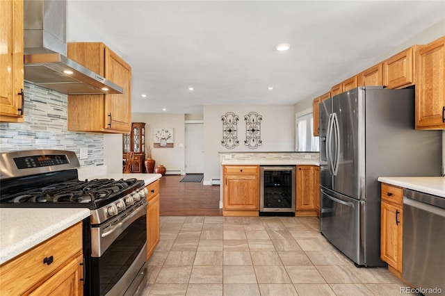 27436 Kennedy Gulch Rd, Conifer, CO 80433 - kitchen with appliances with stainless steel finishes, beverage cooler, wall chimney range hood, backsplash, and light countertops