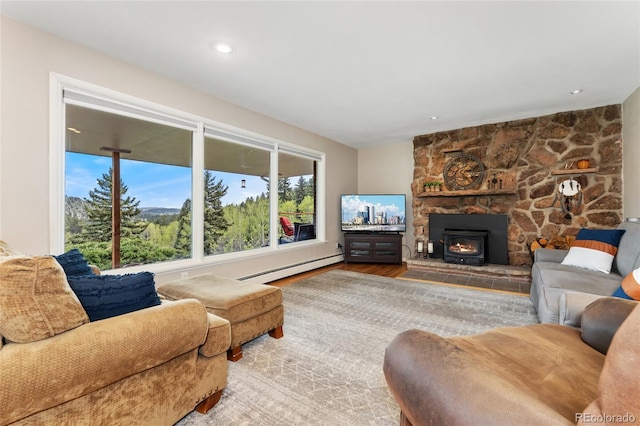 27436 Kennedy Gulch Rd, Conifer, CO 80433 - living area with a baseboard radiator, wood finished floors, and a wood stove