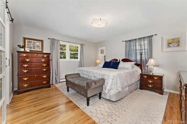 27436 Kennedy Gulch Rd, Conifer, CO 80433 - bedroom featuring light wood-type flooring and a baseboard heating unit