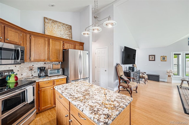 401 N Columbine St, Golden, CO 80403 - kitchen featuring appliances with stainless steel finishes, high vaulted ceiling, light wood-type flooring, decorative backsplash, and brown cabinets