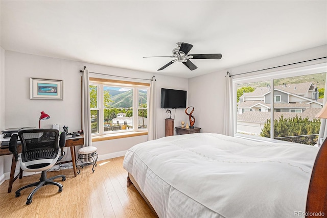 401 N Columbine St, Golden, CO 80403 - bedroom with wood finished floors, baseboards, a desk, and a ceiling fan
