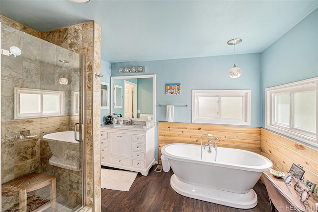 401 N Columbine St, Golden, CO 80403 - full bath with vanity, a freestanding bath, wood finished floors, a shower stall, and wainscoting