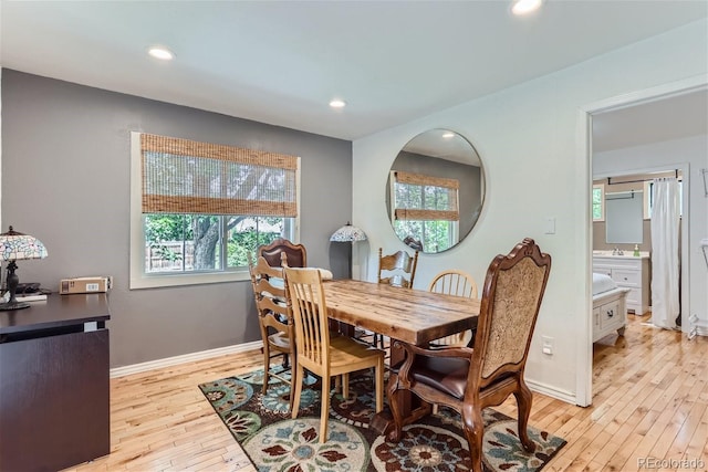 dining space with light hardwood / wood-style floors