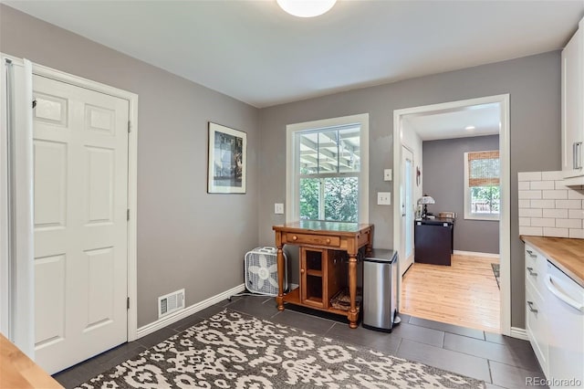 entryway featuring dark tile patterned flooring