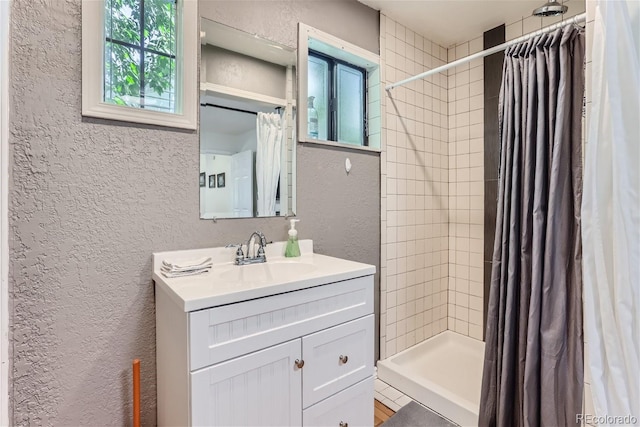 bathroom featuring a shower with curtain and vanity