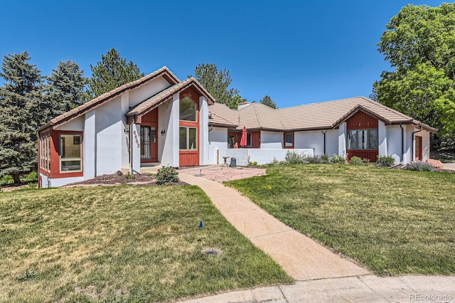 6663 S Prescott Way, Littleton, CO 80120 - view of front facade featuring stucco siding, a tiled roof, and a front yard