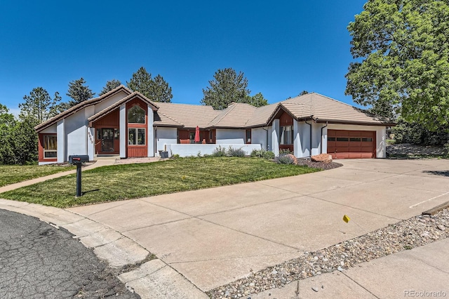 6663 S Prescott Way, Littleton, CO 80120 - ranch-style house featuring an attached garage, a front lawn, a tile roof, driveway, and stucco siding