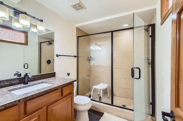 6663 S Prescott Way, Littleton, CO 80120 - bathroom featuring toilet, vanity, and a stall shower
