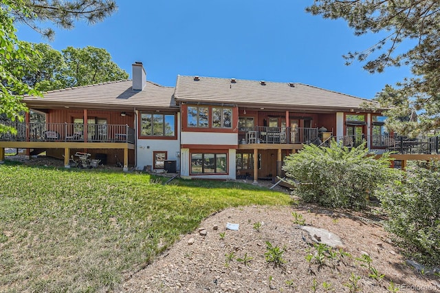 6663 S Prescott Way, Littleton, CO 80120 - back of property with a chimney, a lawn, and a tiled roof