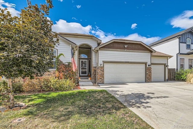 view of front of home with a garage and a front lawn