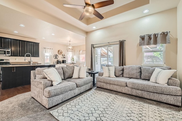 living room with ceiling fan, plenty of natural light, and hardwood / wood-style floors