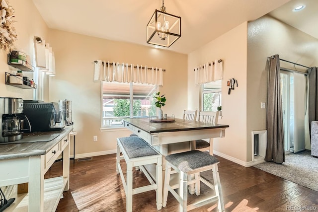 dining room featuring an inviting chandelier and dark hardwood / wood-style floors