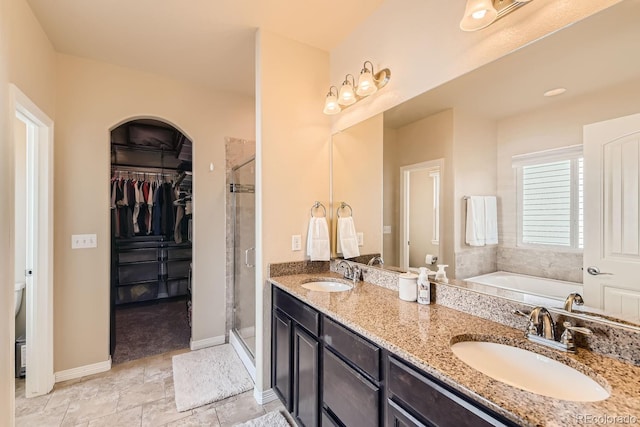 bathroom featuring vanity and independent shower and bath