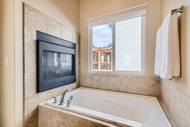 bathroom featuring tiled tub