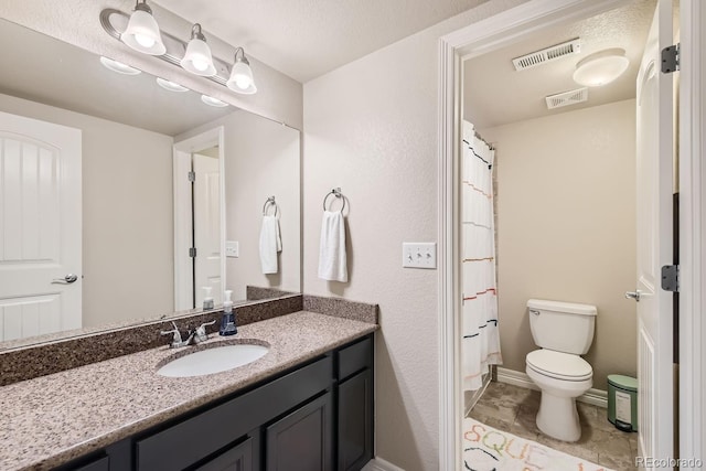 bathroom featuring toilet, a shower with curtain, and vanity