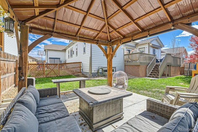 view of patio with a gazebo, central air condition unit, and an outdoor living space with a fire pit