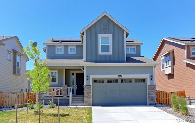 10983 Uvalda St, Commerce City, CO 80022 - craftsman-style house with board and batten siding, covered porch, solar panels, driveway, and stone siding