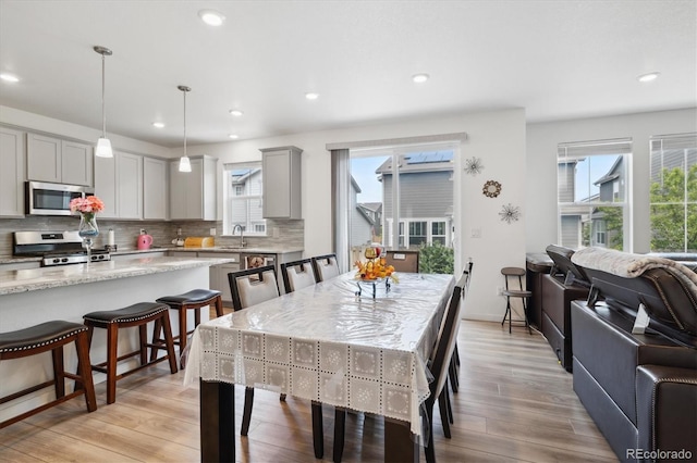 10983 Uvalda St, Commerce City, CO 80022 - dining area featuring light wood-style flooring and recessed lighting