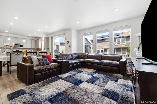 10983 Uvalda St, Commerce City, CO 80022 - living area featuring healthy amount of natural light, light wood-style floors, and recessed lighting