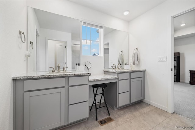 10983 Uvalda St, Commerce City, CO 80022 - full bath featuring two vanities, baseboards, tile patterned flooring, and recessed lighting