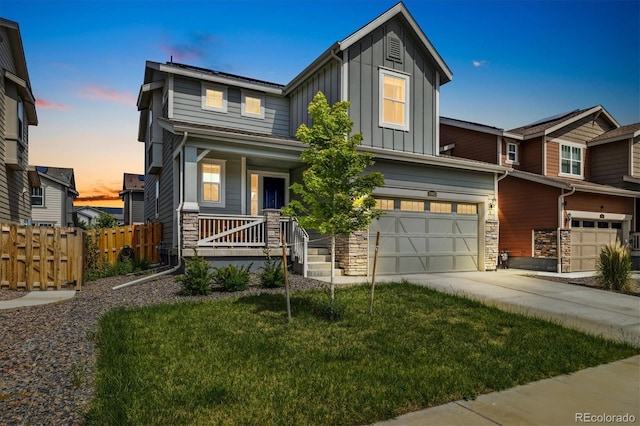 10983 Uvalda St, Commerce City, CO 80022 - view of front of property with board and batten siding, an attached garage, a porch, stone siding, and concrete driveway