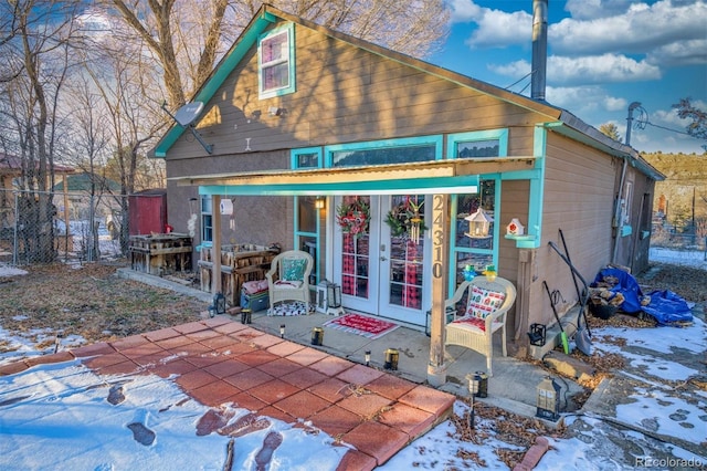 snow covered property featuring french doors