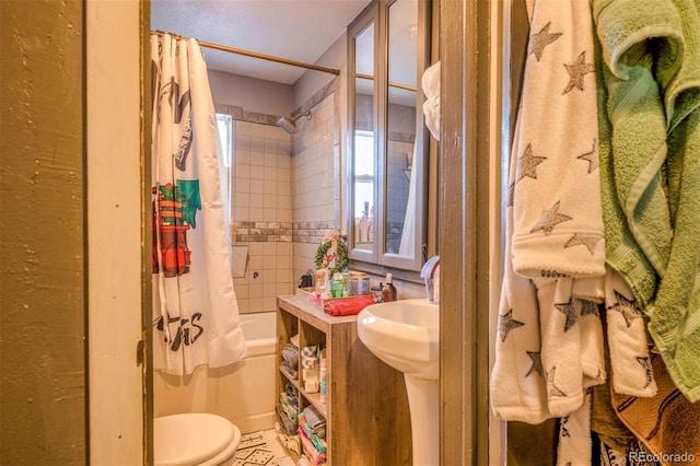 bathroom with shower / tub combo with curtain and toilet